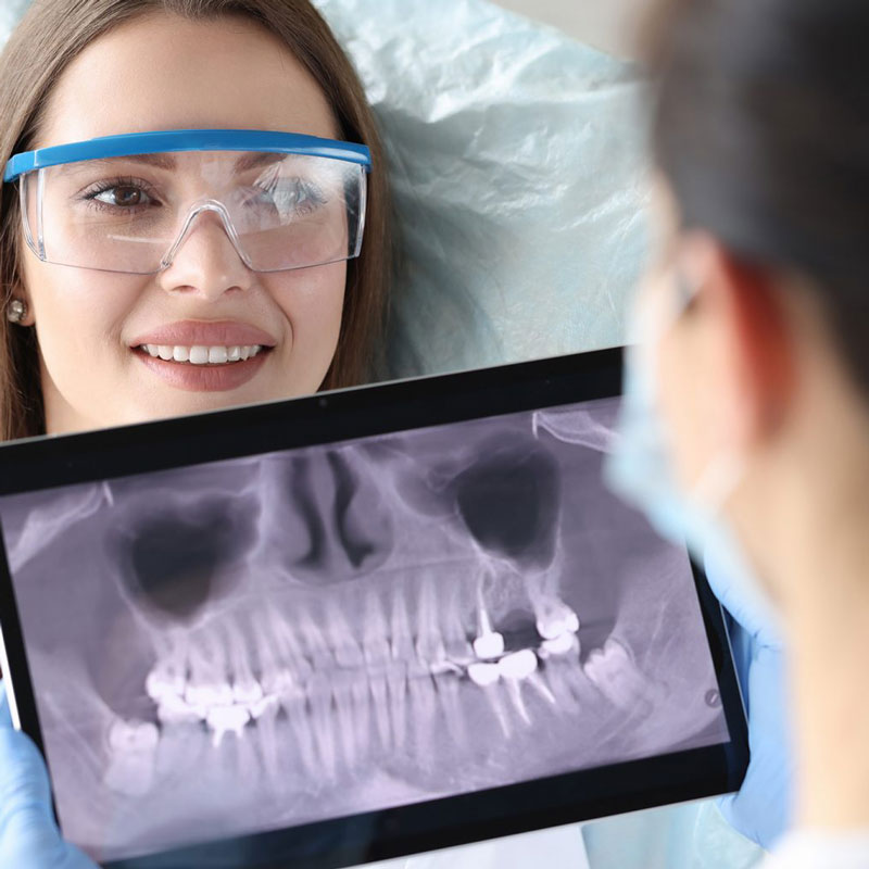 ladies looking at xray of teeth